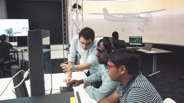 2017-05-CEAP0025CEAP0035CEAP-AIRC-Air Traffic Management Lab-students and tutor with aircraft on lit screen behind-landscape-01