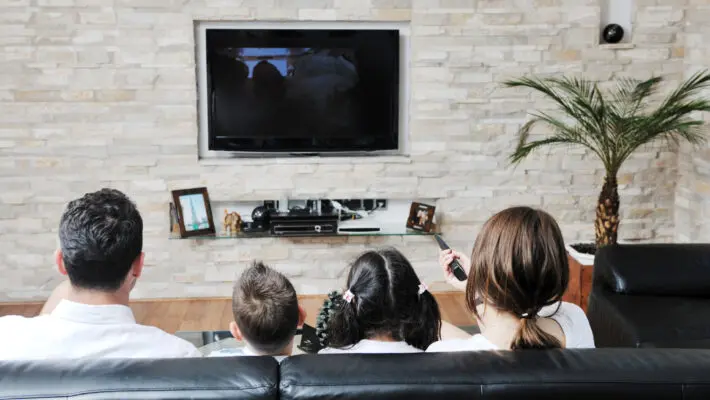 Happy young family have fun and working on laptop at modern  home livingroom indoor