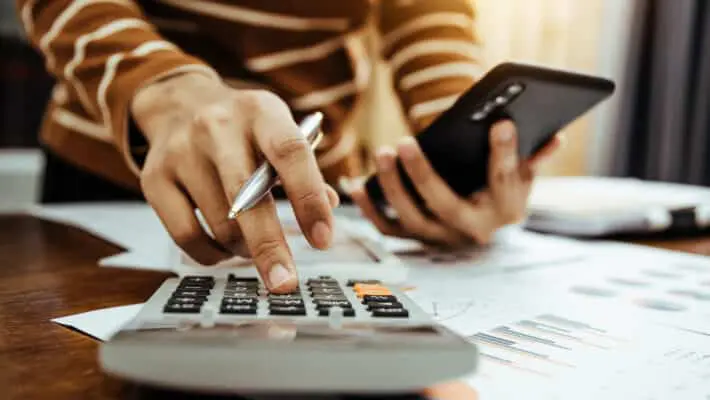 Female accountant or banker making calculation of finance and economy banking concept.