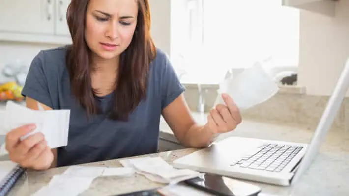 woman looking at bills
