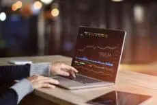 Businessman,Using,Laptop,For,Analyzing,Data,Stock,Market,,Forex,Trading