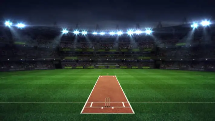 Illuminated,Round,Cricket,Stadium,Full,Of,Fans,At,Night,Upper