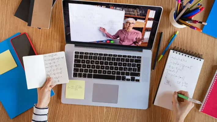 High,Angle,View,Of,Video,Conference,With,Teacher,On,Laptop