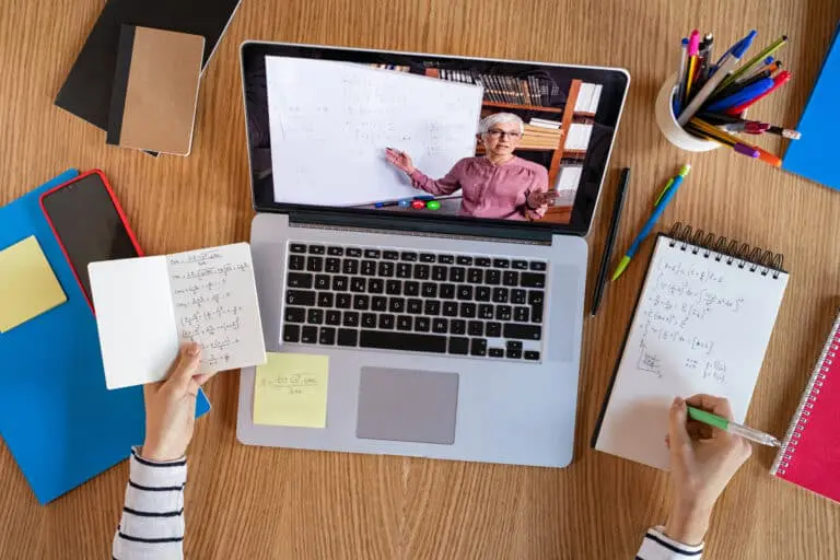 High,Angle,View,Of,Video,Conference,With,Teacher,On,Laptop