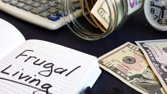 Frugal,Living,Written,On,A,Note,Pad,And,Money.