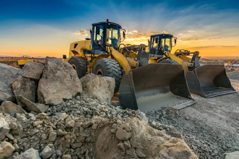 Two,Excavators,Moving,Stone,And,Rock,In,A,Construction,Site
