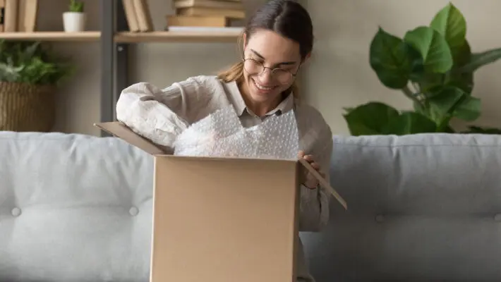 Smiling,Satisfied,Young,Woman,Customer,Sit,On,Sofa,Unpack,Package