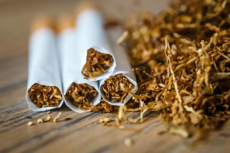Cut,Tobacco,Leaves,And,Handmade,Cigarettes,On,A,Wooden,Background