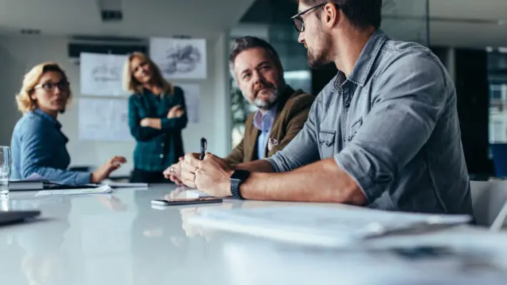 Businessman,Explaining,New,Business,Ideas,To,Peers.,Business,People,Discussing