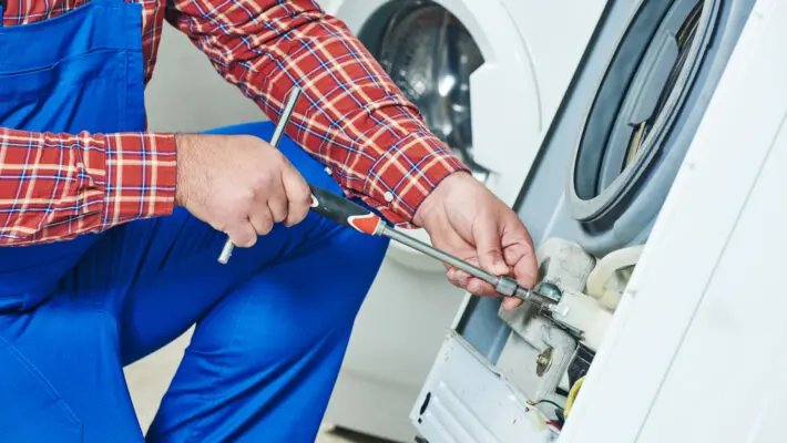 Washing,Machine,Repair.,Repairer,Hands,With,Screwdriver,Disassembling,Damaged,Unit