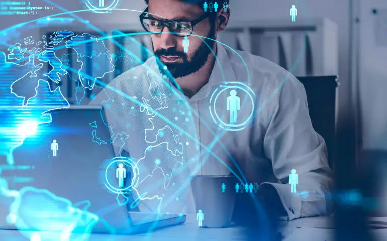 Bearded,Businessman,Using,Laptop,In,Blurry,Office,With,Double,Exposure
