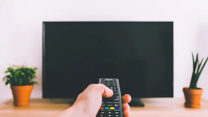 Television,With,Remote,Control,In,Hand,Mockup