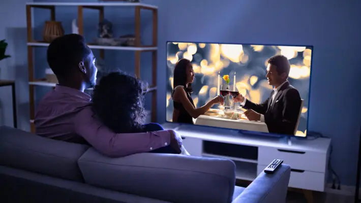 Affectionate,Young,Family,Watching,Tv,At,Home