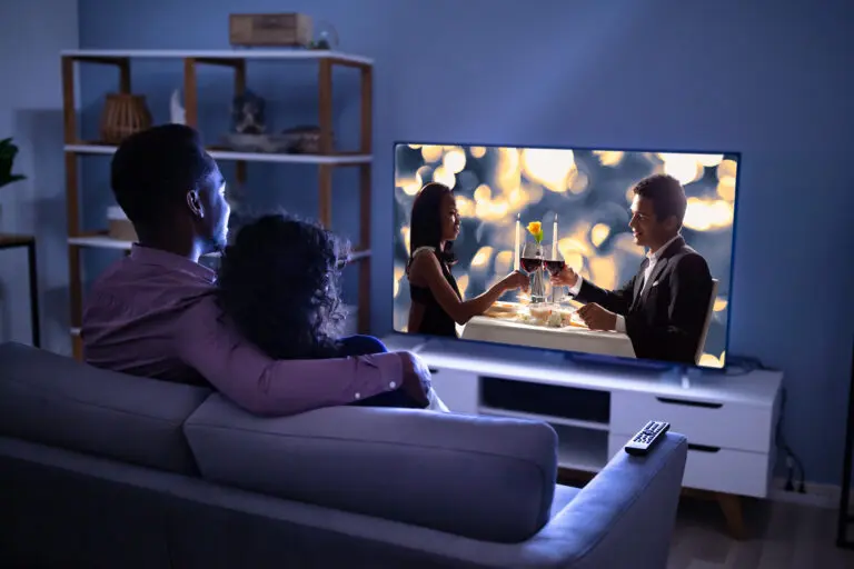 Affectionate,Young,Family,Watching,Tv,At,Home