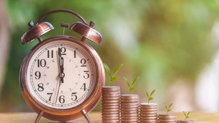 Money,Coin,Stack,Growing,Graph,With,Alarm,Clock,To,Profit