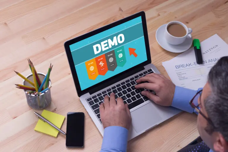 Man,Working,On,Laptop,With,Demo,On,A,Screen