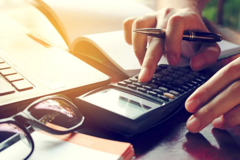 Close,Up,Man,Calculate,Cost,On,Desk,At,Home.