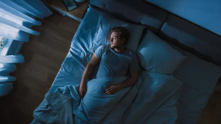 Top,View,Of,Handsome,Young,Man,Sleeping,Cozily,On,A