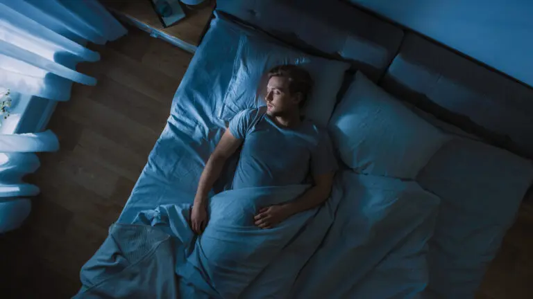 Top,View,Of,Handsome,Young,Man,Sleeping,Cozily,On,A