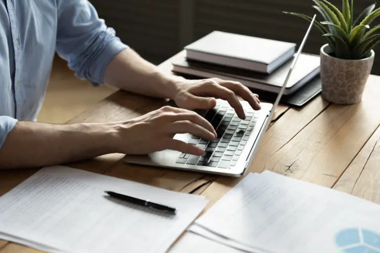 Close,Up,Businessman,Using,Laptop,,Typing,On,Keyboard,,Sitting,At
