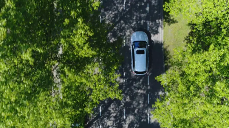 Aerial,Top,Down,View,Of,Grey,Station,Wagon,Vehicle,Overtaking
