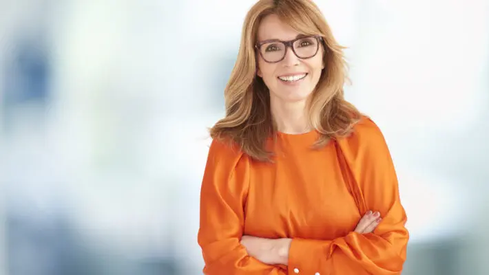 Portrait of executive middle aged businesswoman looking at camer
