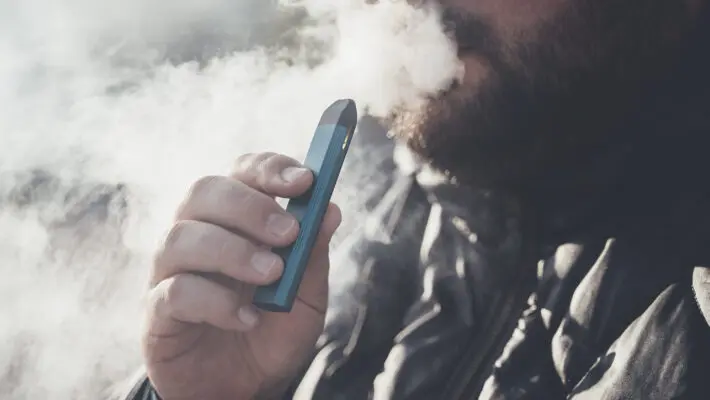 Man,Smokes,New,Vape,Pod,System,,Inhales,And,Exhales,Vapor