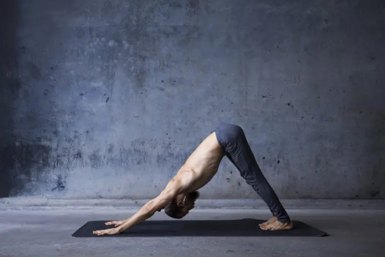 Young,Man,Practicing,Yoga,In,A,Urban,Background