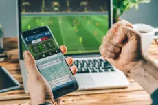 Man,Watching,Football,Play,Online,Broadcast,On,His,Laptop,,Cheering