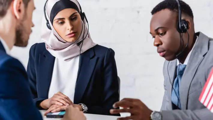 Arabian,And,African,American,Business,People,In,Headsets,Near,Digital