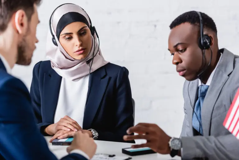 Arabian,And,African,American,Business,People,In,Headsets,Near,Digital