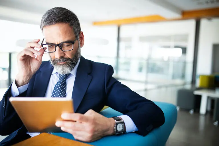 Shot of thinking financial advisor businessman working in office.