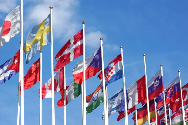 World,Flags,Blowing,In,The,Wind,On,The,Cloudy,Sky