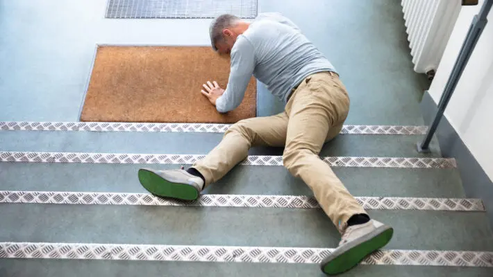 Mature,Man,Lying,On,Staircase,After,Slip,And,Fall,Accident