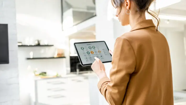 Woman,Controlling,Smart,Home,Devices,Using,A,Digital,Tablet,With