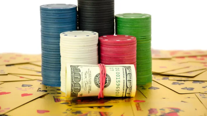 A,Stack,Of,Chips,Stays,On,Gold,Cards,With,Roll