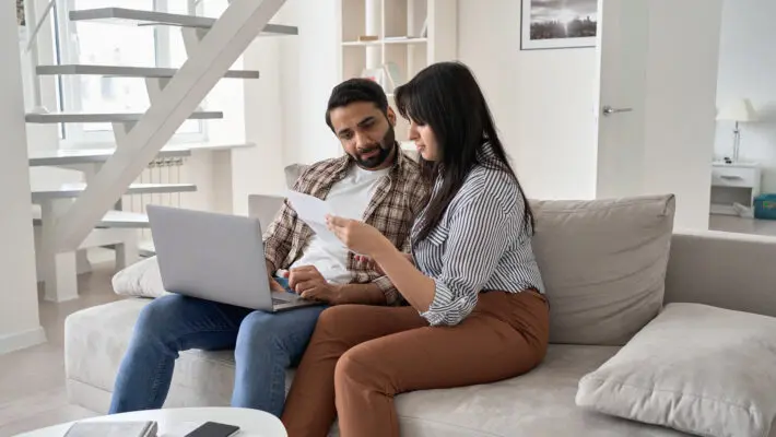 Young,Indian,Couple,Checking,Paper,Bills,Paying,Mortgage,Loan,Bank