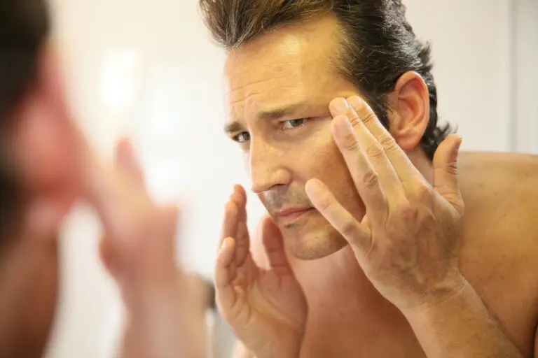 Middle-aged,Man,In,Bathroom,Applying,Facial,Lotion