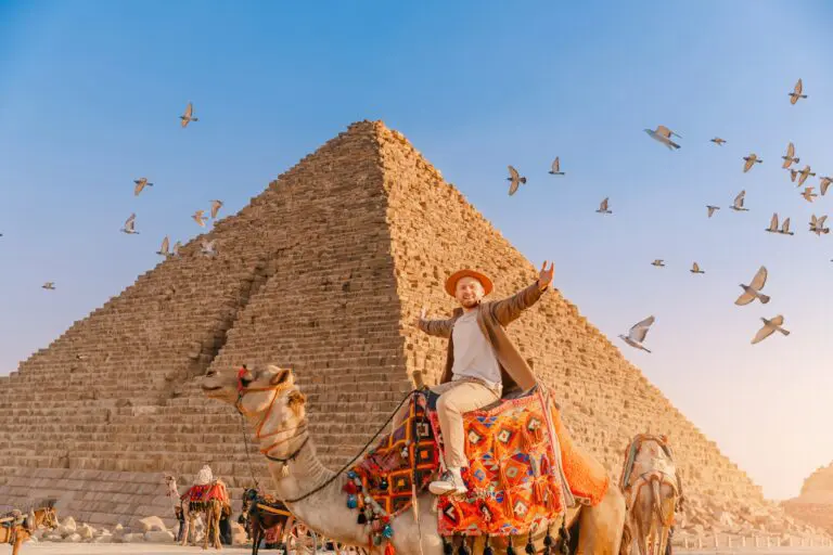 Tourist,Man,With,Hat,Riding,On,Camel,Background,Pyramid,Of