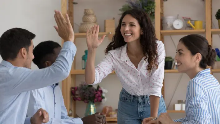 Happy,Excited,Two,Employees,Giving,High,Five,,Celebrating,Team,Success,