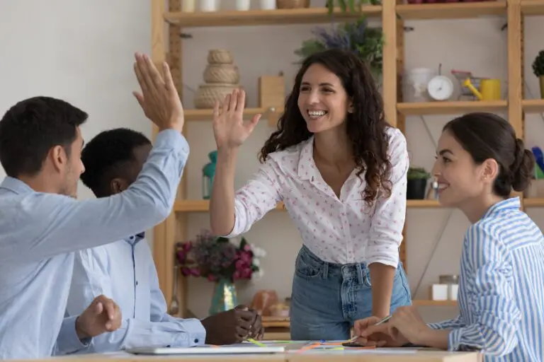 Happy,Excited,Two,Employees,Giving,High,Five,,Celebrating,Team,Success,