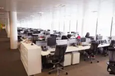 Half of the largest international employers are planning to cut their office space in the next three years, according to a survey, as they struggle to manage the complex nature of the post-Covid workplace.