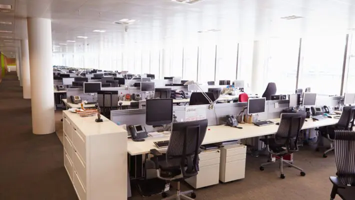 Half of the largest international employers are planning to cut their office space in the next three years, according to a survey, as they struggle to manage the complex nature of the post-Covid workplace.