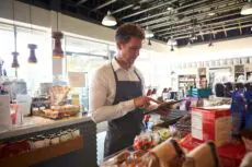 Employee,In,Delicatessen,Checking,Stock,With,Digital,Tablet