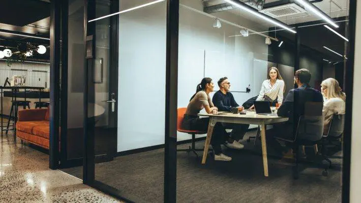 Team,Of,Diverse,Businesspeople,Having,A,Meeting,In,A,Transparent