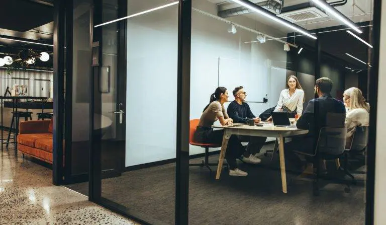 Team,Of,Diverse,Businesspeople,Having,A,Meeting,In,A,Transparent