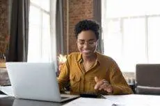 Happy,Young,Afro,American,Entrepreneur,Woman,In,Glasses,Counting,Profit,