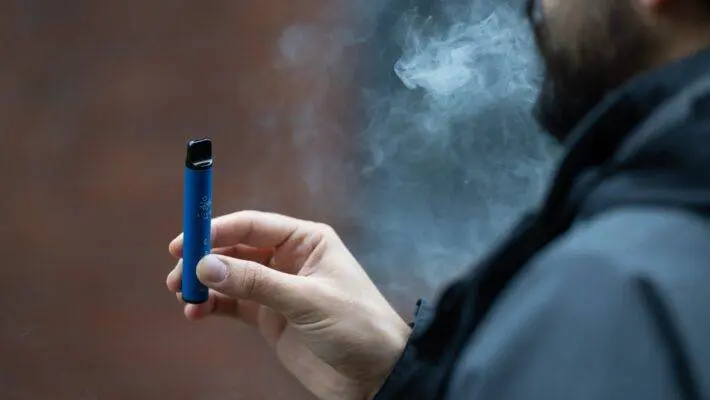 An e-cigarette, or vape, is a battery-operated device used for inhaling vapor with nicotine and flavoring.