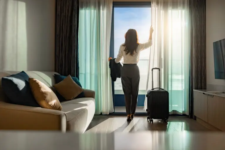Confident,Businesswoman,Wearing,White,Shirt,And,Holding,Suit,With,Suitcase