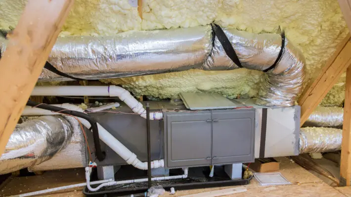 Wooden roof beams with insulates the attic with mineral wool and pipe heating system